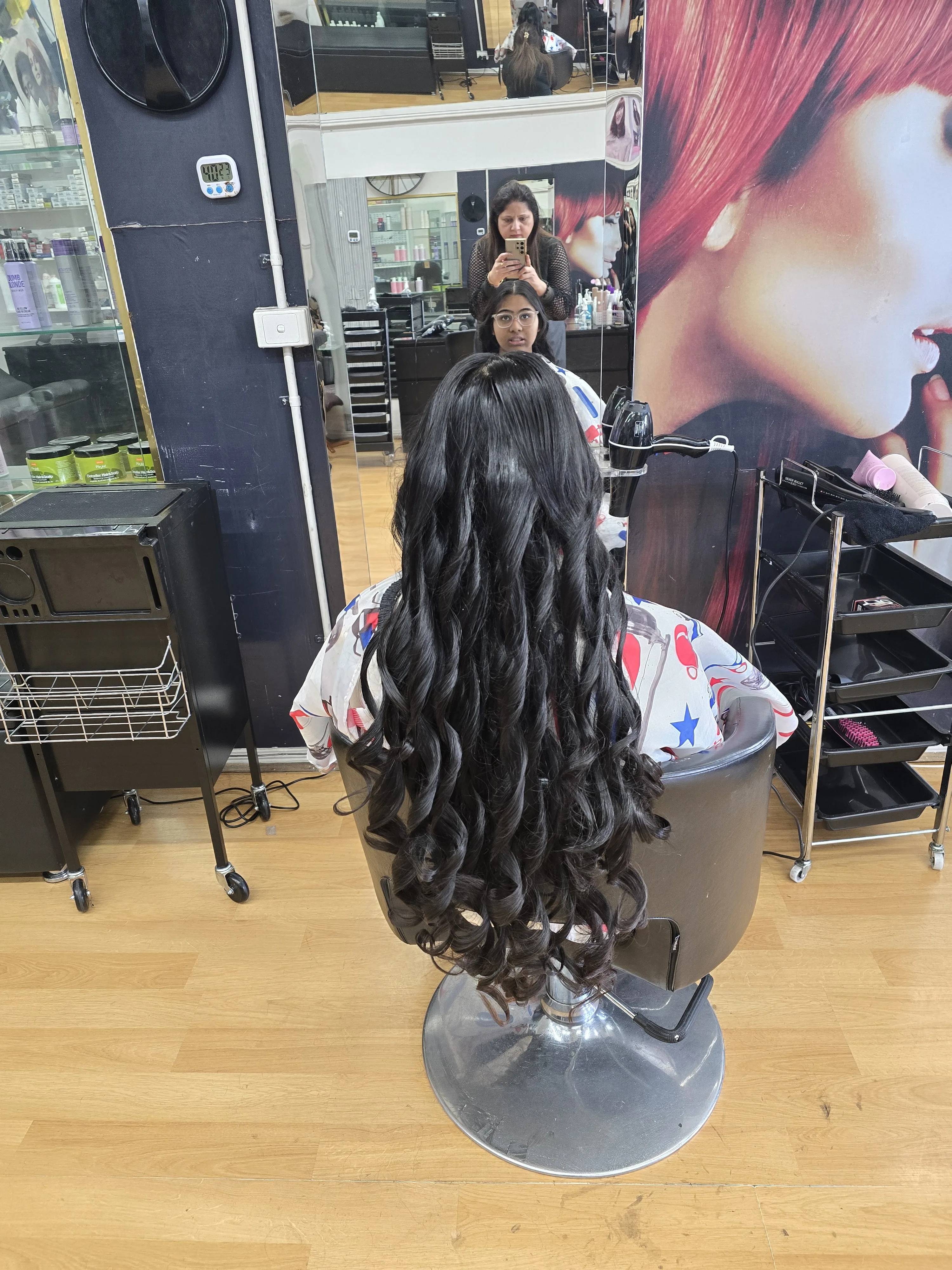 Rear view of very long wavy hair extensions against red-hair model poster