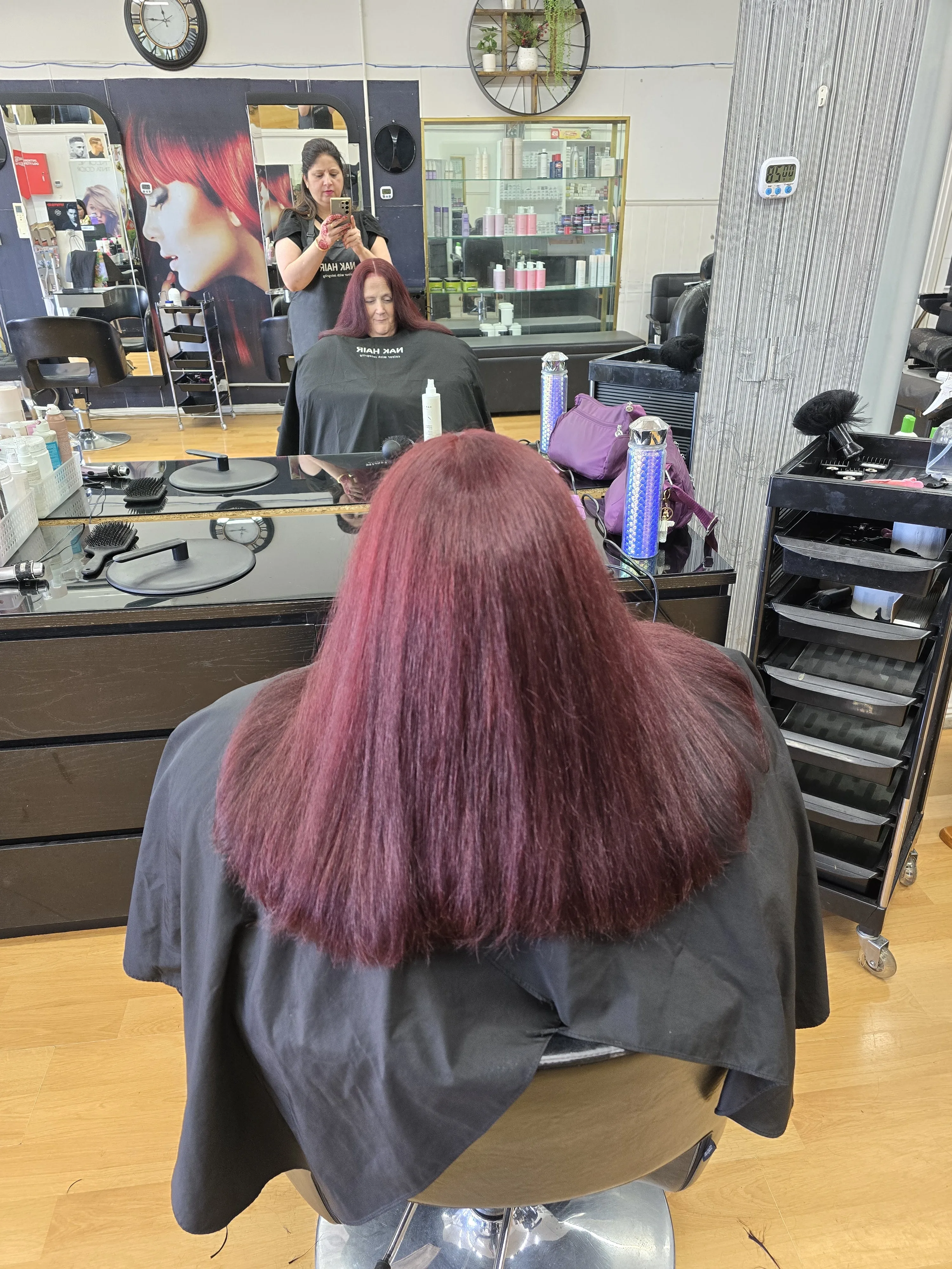 Rear view of a glossy vivid magenta-red sleek blow-dry