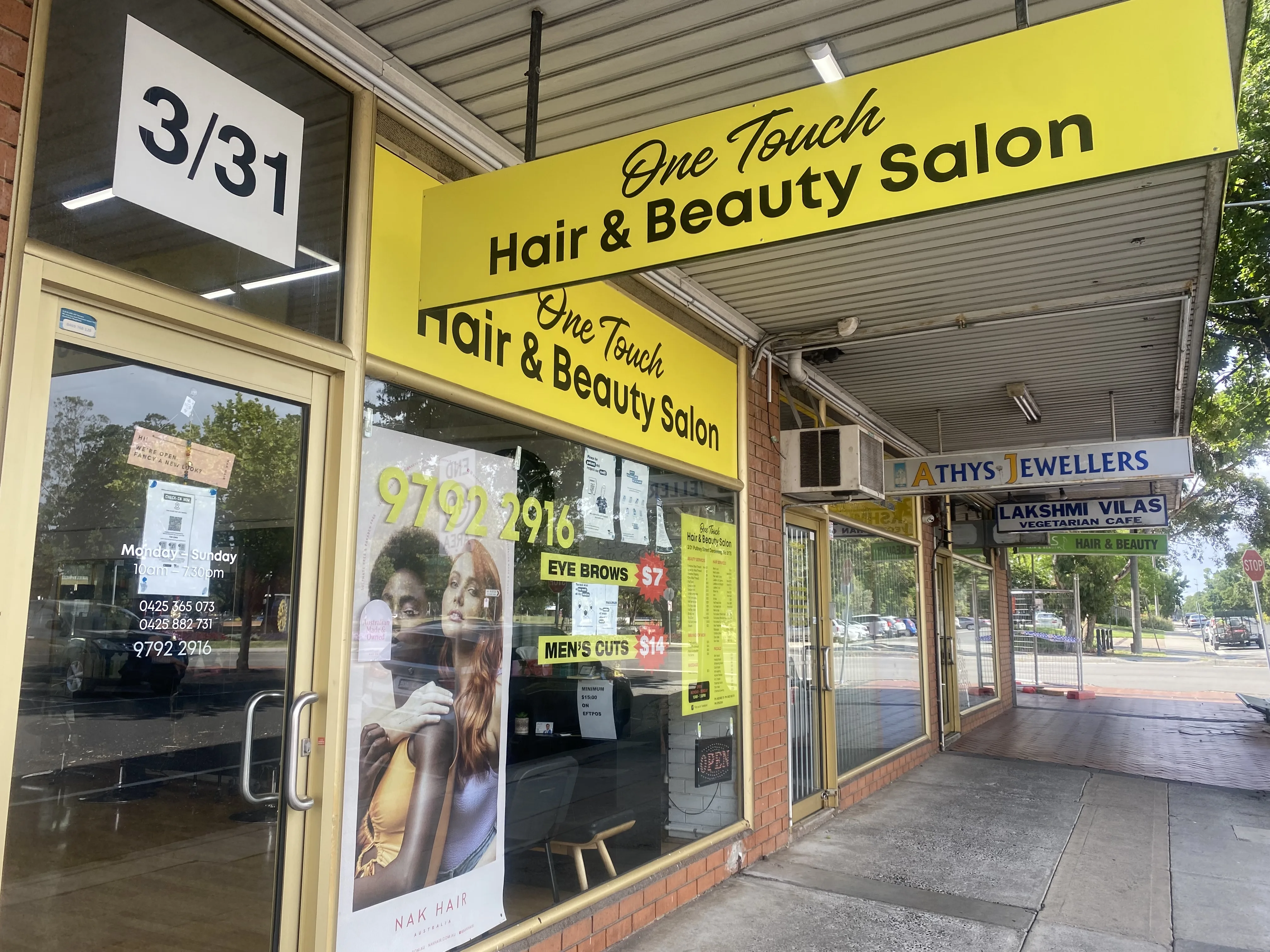 Exterior close-up of the shopfront facia and window posters at 3/31 Pultney Street